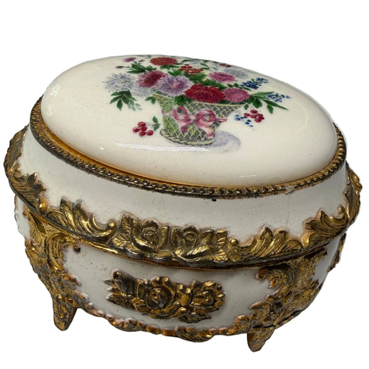 Decorative box with floral design and gold accents on a white surface