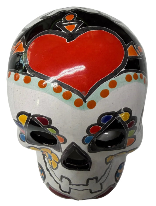 Decorative skull with colorful patterns on a white surface